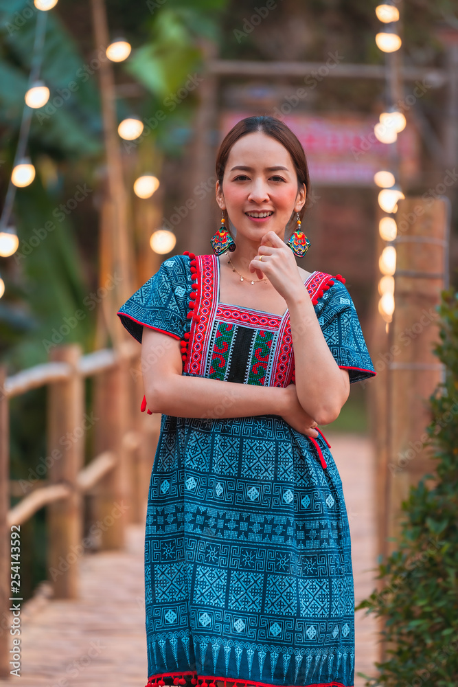 asian girl in holiday by posing smile relaxation in nature mountain and watercourse by wearing lanna dress north thailand