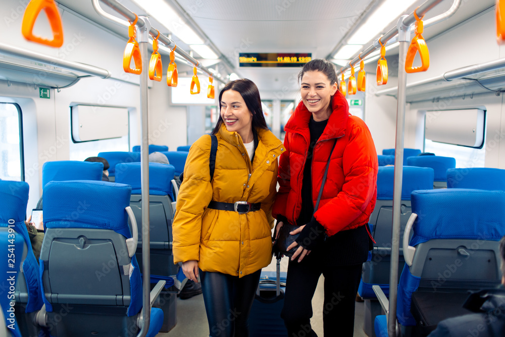 Young positive females in railway train. Young positive females in railway train.