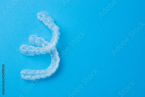 Plastic caps for teeth on a blue background