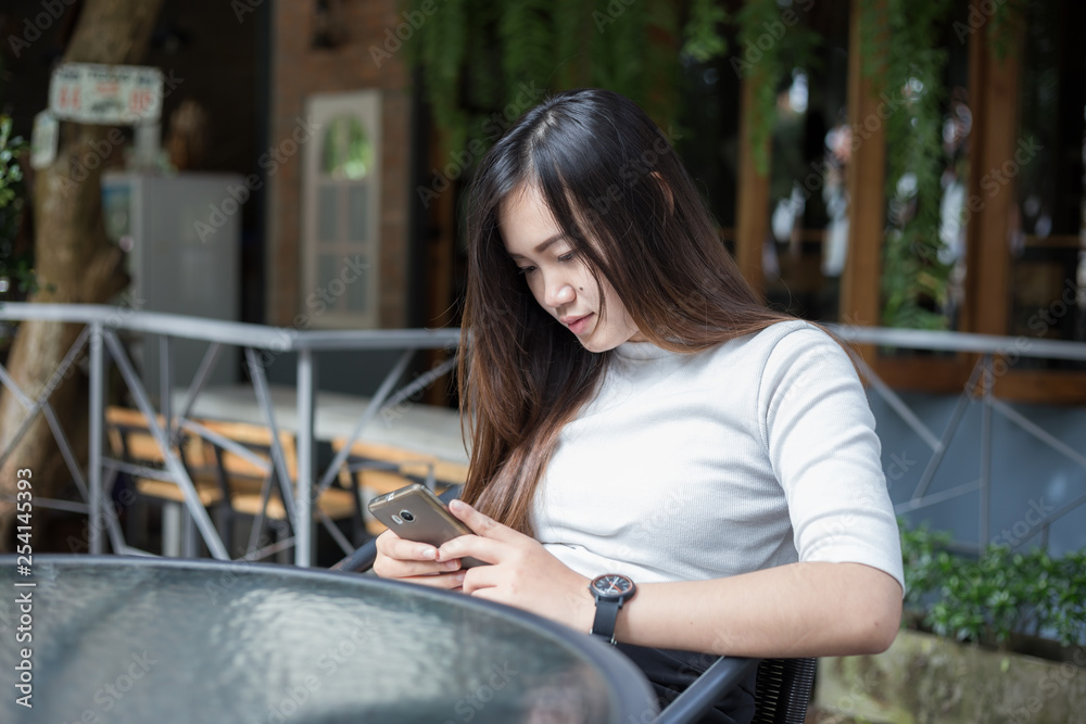 Business asian casual women use smartphone sitting in cafe