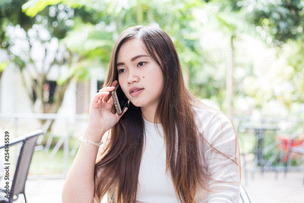 Business asian casual women use smartphone sitting in cafe Business asian casual women use smartphone sitting in cafe
