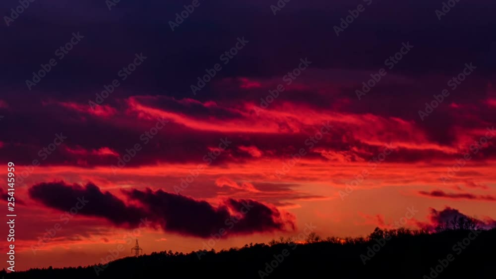 Red fiery sunset sky with fast moving clouds, time lapse nature background. Red fiery sunset sky with fast moving clouds, time lapse nature background.
