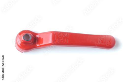 Red handle of the water tap on a white background