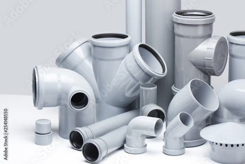 Plumbing, sewage. Gray polypropylene tubes on a white background in futuristic style