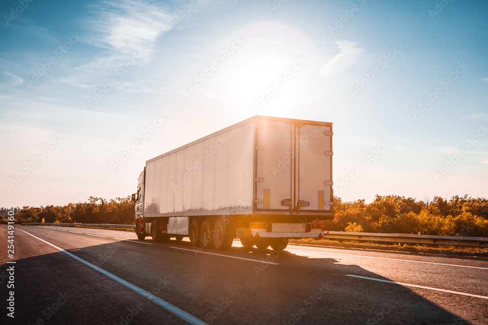 semitruck driving to sunset