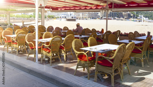 The Table and chairs in empty cafe near the beach