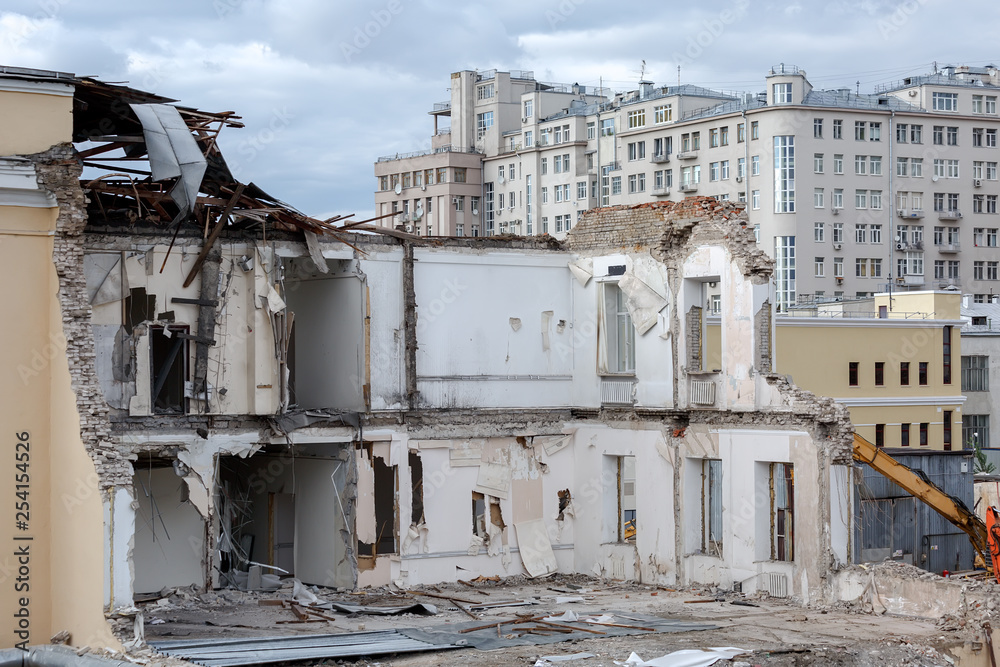 Fototapeta Destruction of a building in the city, residential building in the background, Moscow, September 2016