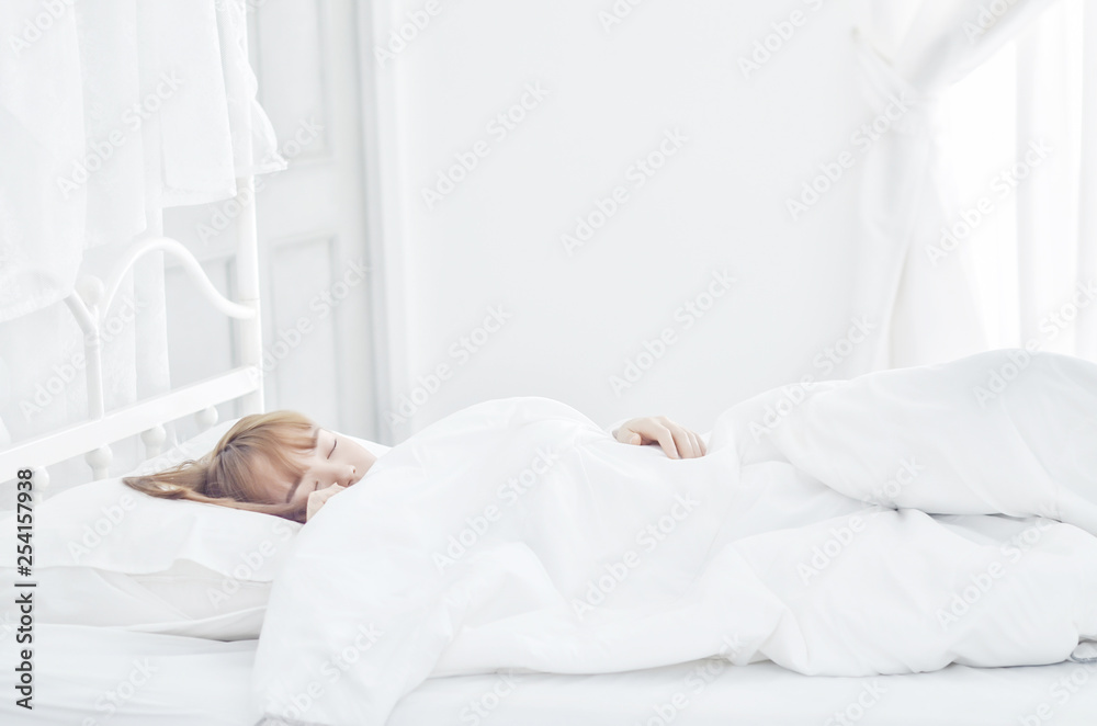 On the bed in the white room.Beautiful woman sleeping in the bedroom.Asian girl sleep well.Sleeping in a white room makes you feel comfortable.Warm tone. On the bed in the white room.Beautiful woman sleeping in the bedroom.Asian girl sleep well.Sleeping in a white room makes you feel comfortable.Warm tone.