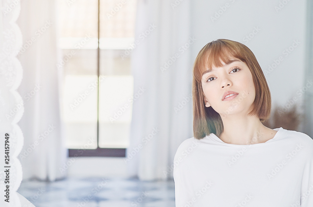 women sit at the edge of the bed. And stretching his arms to relax in the morning.Wake up in the morning.Warm tone.Do not focus on the object. women sit at the edge of the bed. And stretching his arms to relax in the morning.Wake up in the morning.Warm tone.Do not focus on the object.