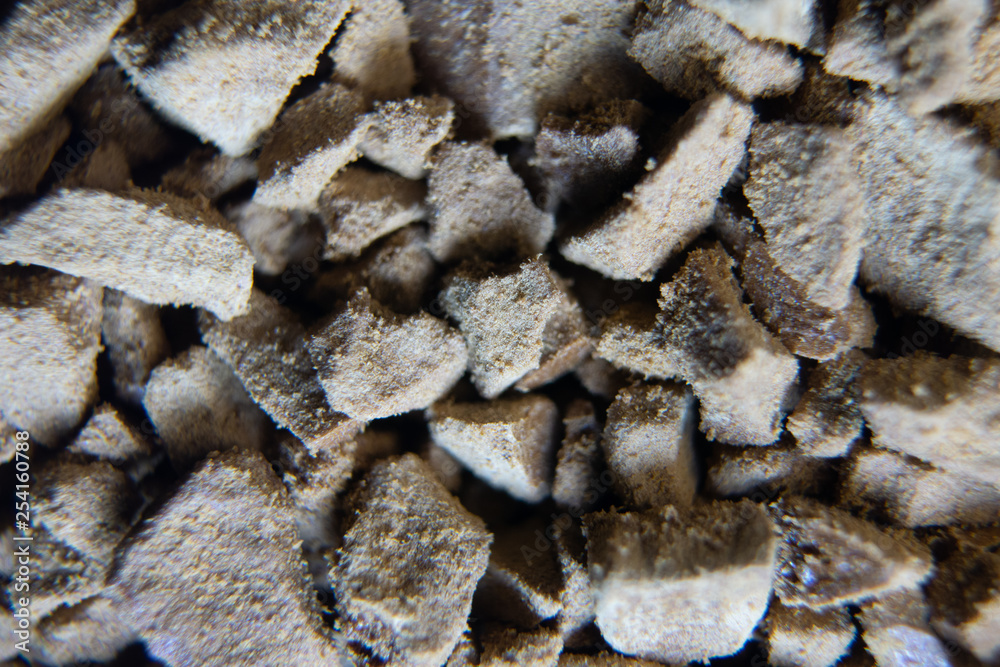 Piled granules texture background macro shot. Instant coffee close-up macro background
