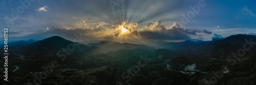 Panorama of landscape at sunset in evening light. beautiful scenery with trees in haze. Panoramic view from arial drone 