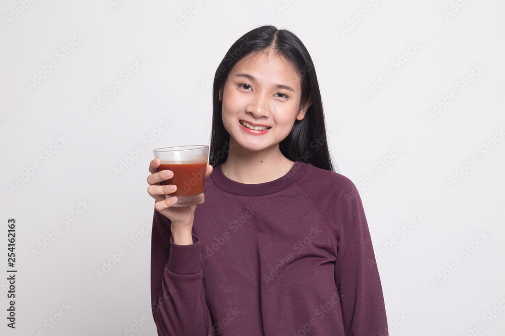 Young Asian woman drink tomato juice. Young Asian woman drink tomato juice.