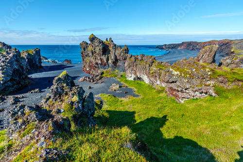 Volcanic lava rocks at Djupalonssandur beach situated on foot of Snaefellsnes peninsula in Western Iceland. photo