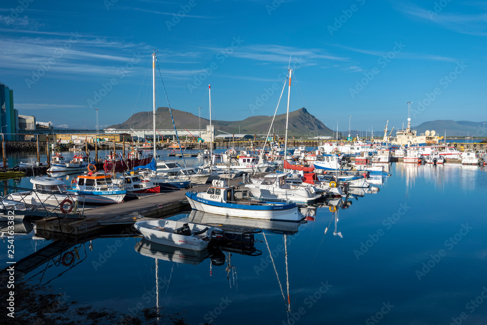 Marine port for fishing boats and private yachts in Akranes town in western coast of Iceland.  Akrafjall mountain massif is at background.