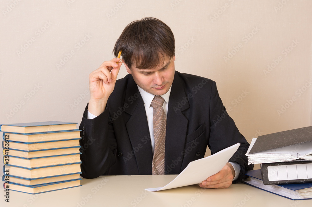 The employee thought about the document at the table in the office The employee thought about the document at the table in the office