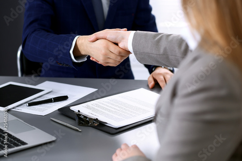 Business people shaking hands, finishing up a meeting. Papers signing, agreement and lawyer consulting concept