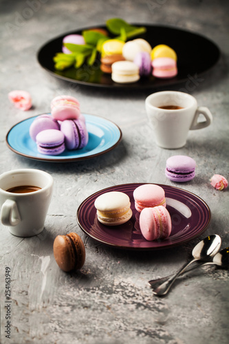 Sweet colorful french macaroons with coffee