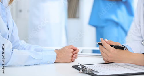 Doctor and patient discussing something  just hands at the table  white background
