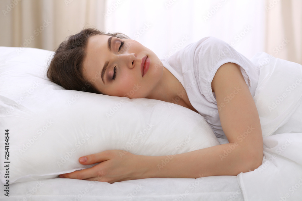 Beautiful young woman sleeping while lying in her bed. Concept of pleasant and rest reinstatement for active life Beautiful young woman sleeping while lying in her bed. Concept of pleasant and rest reinstatement for active life