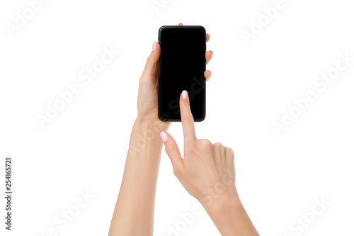 hand holding phone on white background. iPhone 7plus in the girl's hand. iPhones were created and developed by Apple inc. photo