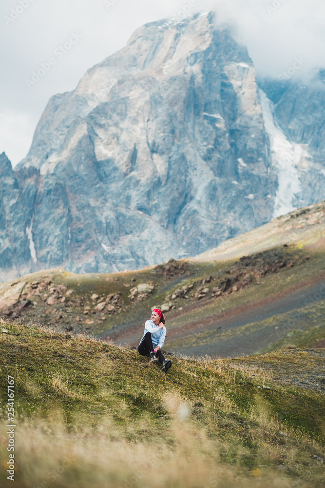  young woman admires the beautiful view in the mountains of Georgia, Caucasus mountain