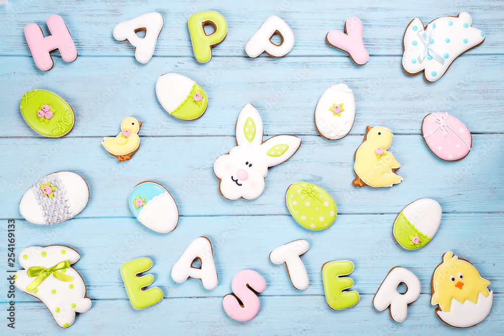 Delicious Easter cookies background. Eggs with different pattern icing on blue wooden background