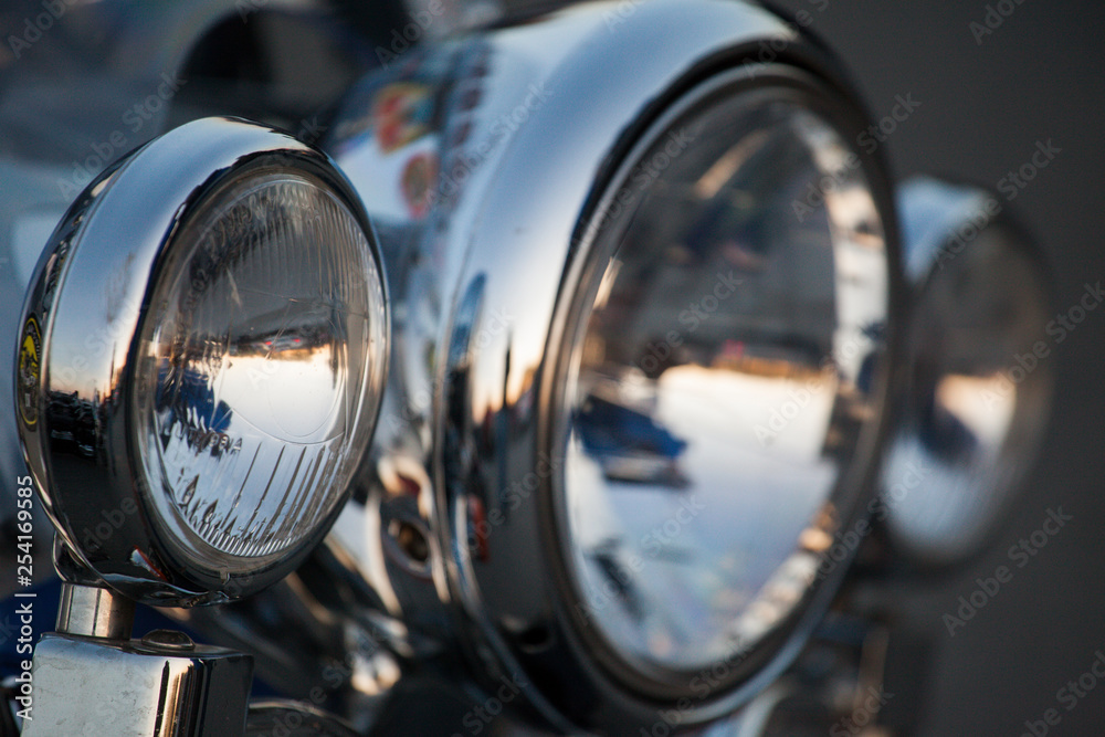 Chromed motorcycle headlights close up Chromed motorcycle headlights close up