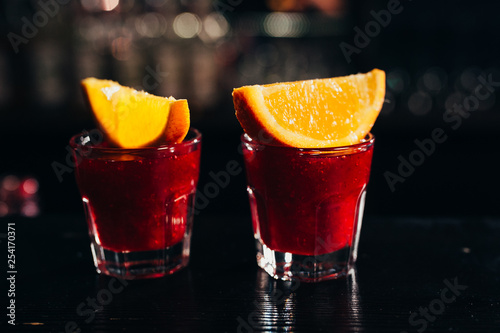 two red shots with orange on a dark background photo