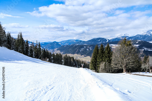 A picture from the ski resort in the austrian Alps. Snow and weather are perfect, slopes are empty. Skiing is passion in these conditions. The mountains around are great visible. 