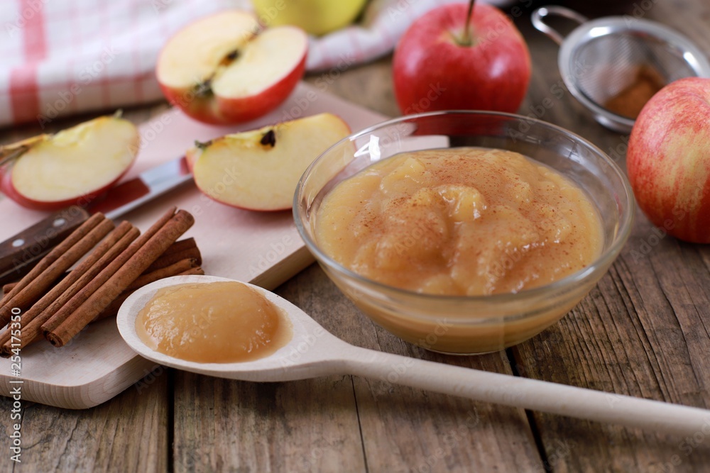 homemade apple jam, with fresh apples and spices with wooden spoon on wooden rustic table homemade apple jam, with fresh apples and spices with wooden spoon on wooden rustic table