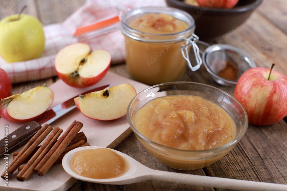 homemade apple jam, with fresh apples and spices with wooden spoon on wooden rustic table homemade apple jam, with fresh apples and spices with wooden spoon on wooden rustic table