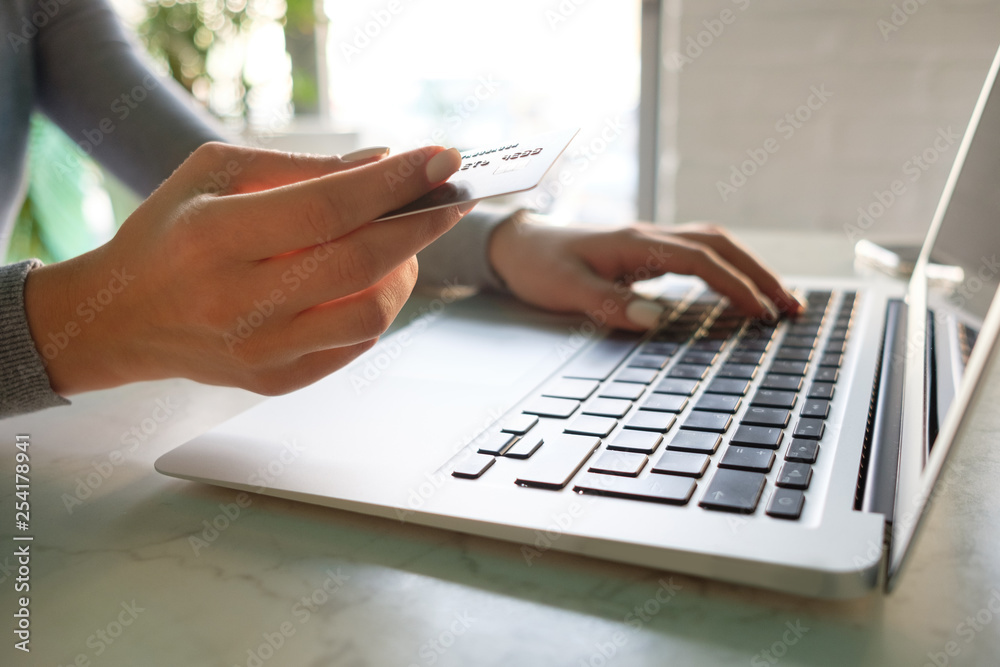 Girl makes online purchases with a credit card Girl makes online purchases with a credit card