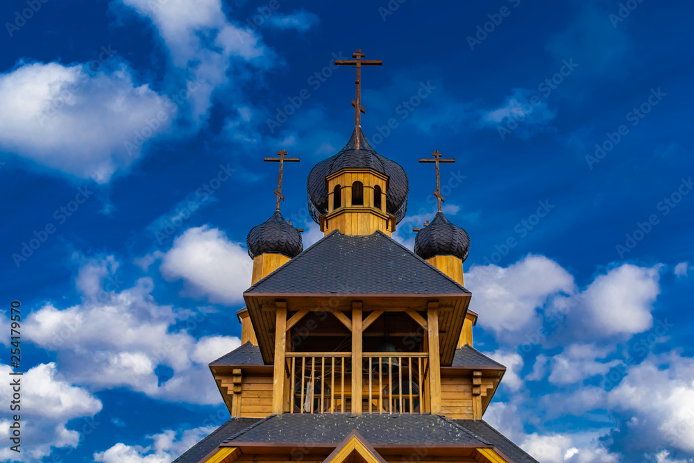 the wooden church on the background of the blue sky