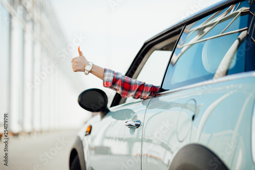 Woman in car driving on the road. Happy beautiful girl traveling in a car.