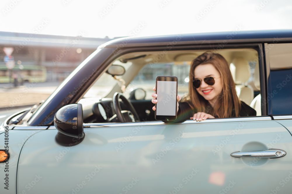 Young Girl driver use her cell phone in car.