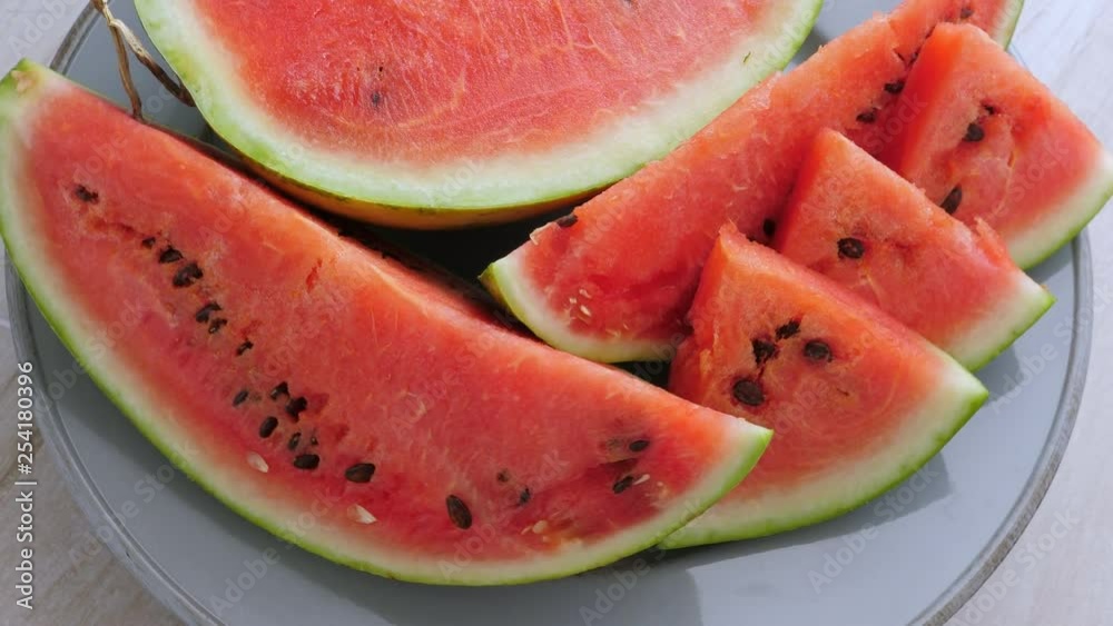 Ripe red watermelon on plate rotating Ripe red watermelon on plate rotating