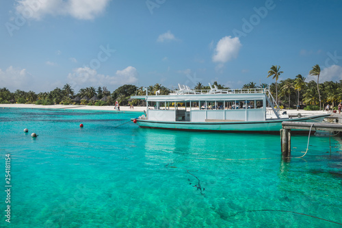 Maldives with the turquoise ocean and boats on the awesome water