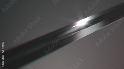 Old medieval sword shining in a spotlight. Light reflects in a sharp blade. 4KHD photo