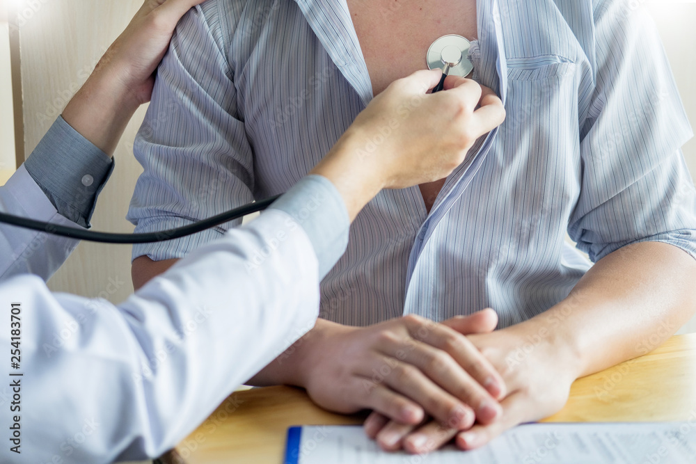 doctor is checking on patient's chest uses stethoscope to listen patient heart rate. doctor is checking on patient's chest uses stethoscope to listen patient heart rate.