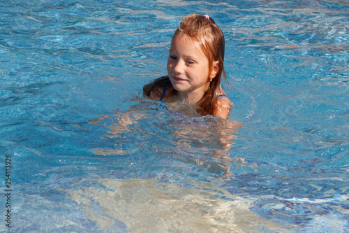girl swims in the pool