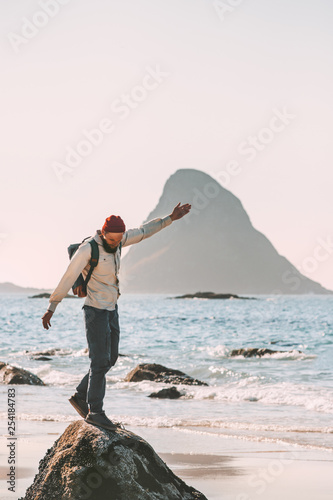 Happy man enjoying ocean beach traveling active lifestyle adventure summer vacations in Norway fun outdoor