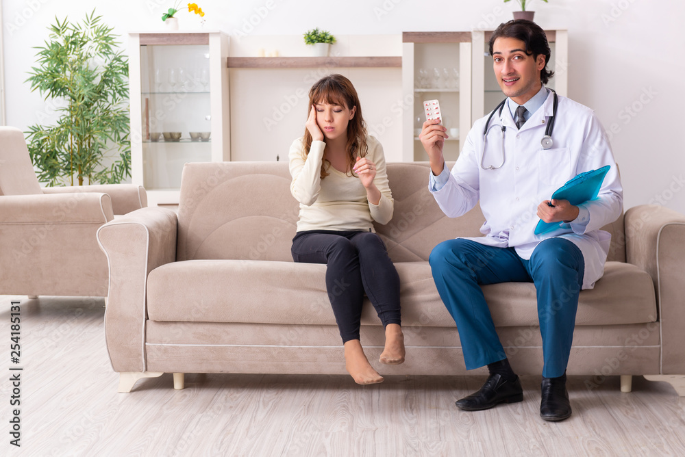 Young handsome doctor visiting female patient at home Young handsome doctor visiting female patient at home