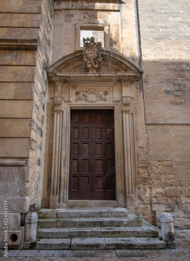 Lecce, Puglia, Italy - Medieval historical center in the old town. View and detail of an ancient gate or door. A region of Apulia