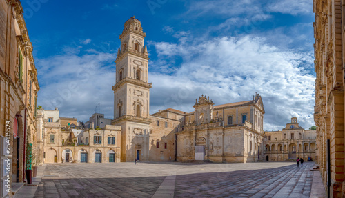 Panorama of Piazza del Duomo square , Campanile tower and Virgin Mary Cathedral ( Basilica di Santa Maria Assunta in Cielo ) , Caritas Diocesana in Lecce - Puglia, Italy. Baroque city of Apulia  photo