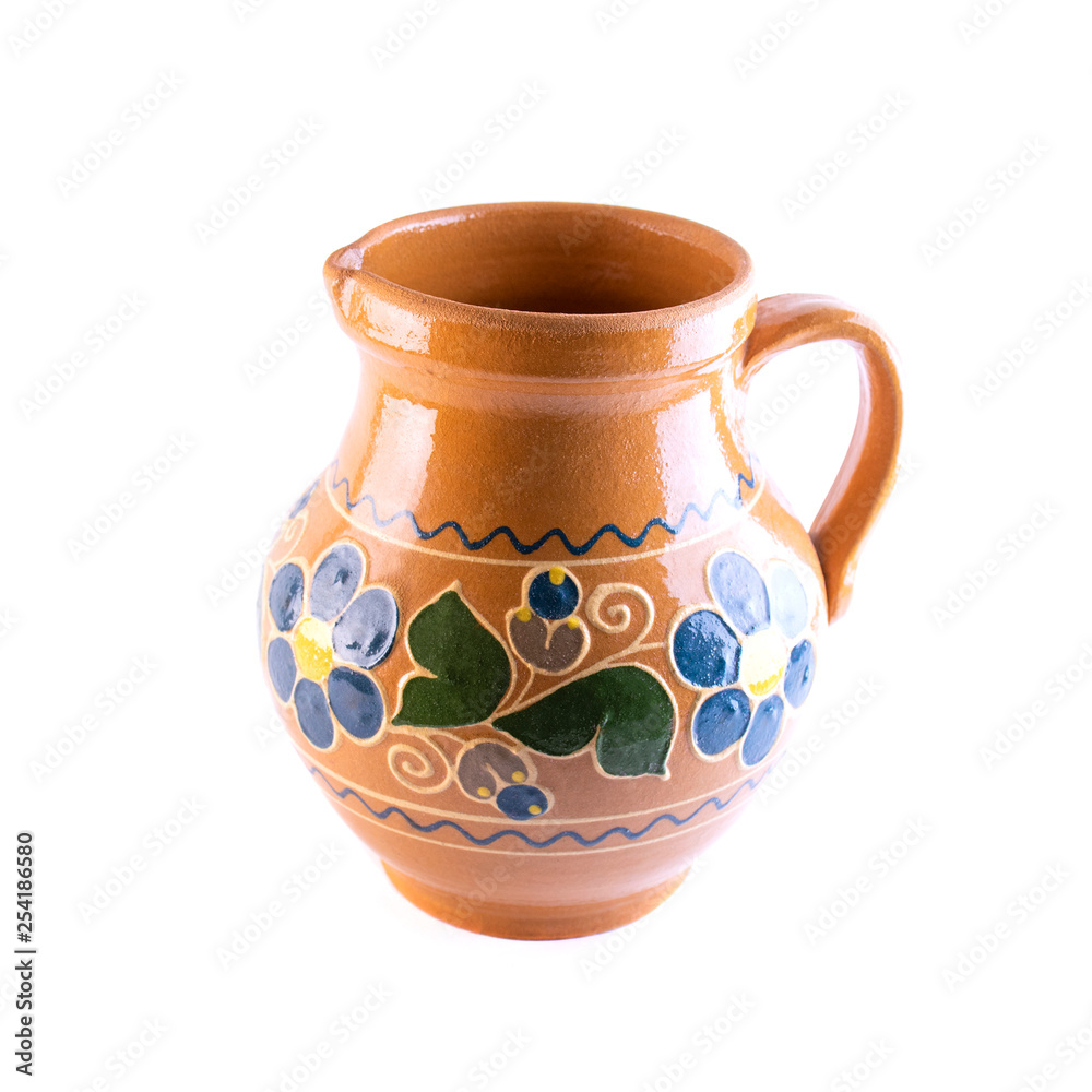 clay jug painted with flowers and fruits  poured on a white background
