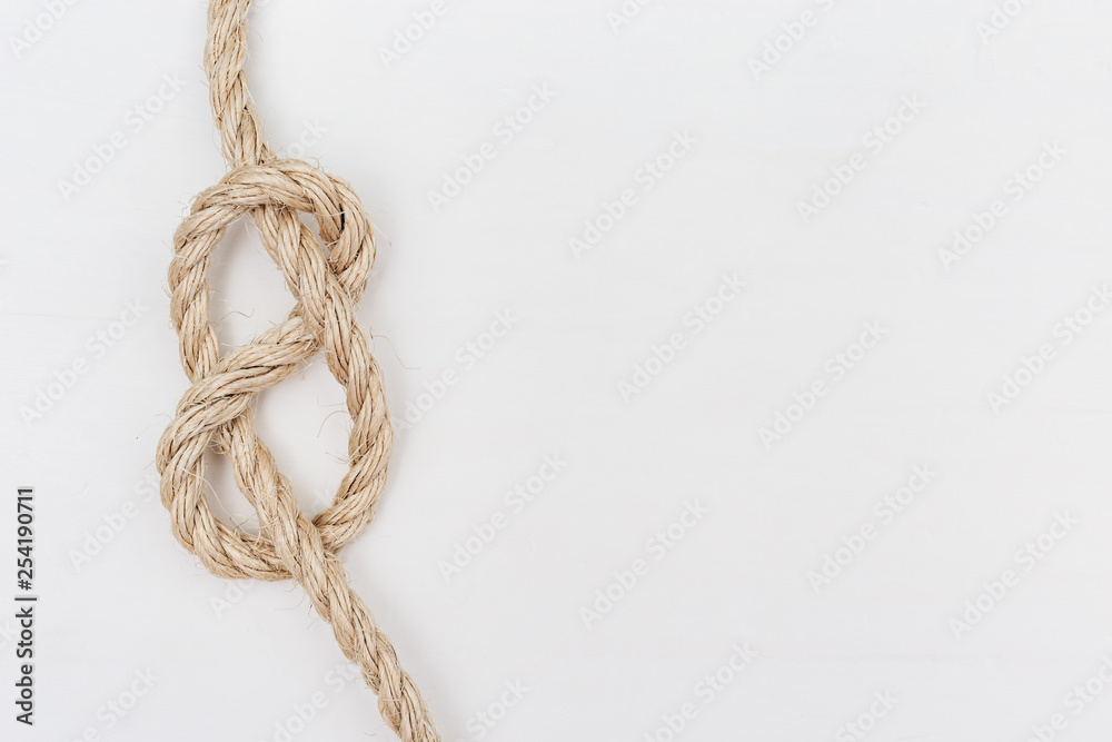 Figure-eight knot or Flemish knot on light rope. Copy space. Figure-eight knot or Flemish knot on light rope. Copy space.