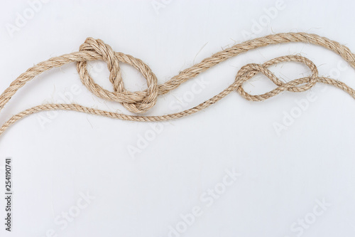 Ship ropes on white wooden background. Double stopper. Copy space.