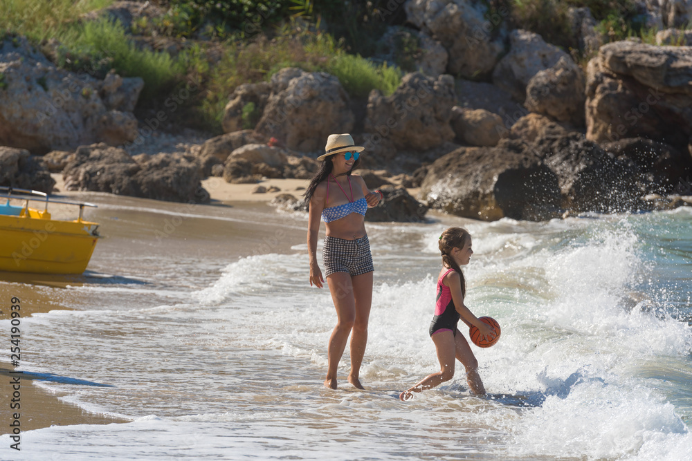 happy family playing together on the beach happy family playing together on the beach