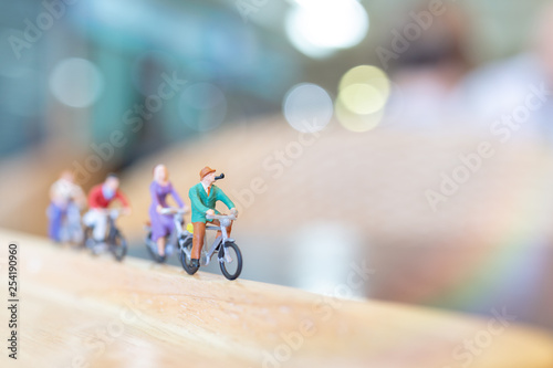 Miniature people  cycling on wooden bridge , Health care concepts