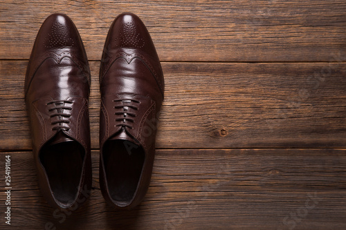 A pair of men shoes close-up on a wooden background.